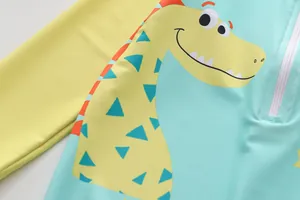 Close-up of children's one-piece swimsuit with cute dinosaur print and front zipper