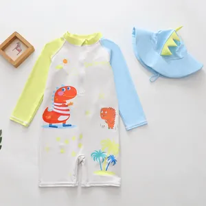 Detail view of boys' cartoon dinosaur one-piece swimsuit set with matching hat