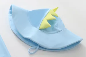 Detail view of a cute light blue children's dinosaur-themed swim hat with yellow spikes