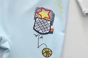 Close-up of boys light blue one-piece swimsuit featuring cartoon basketball print