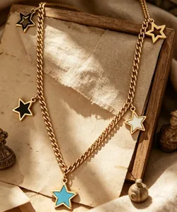 Close-up detail of multi-colored enamel star pendants on 18K gold plated curb chain.