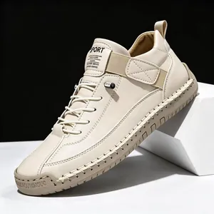 Stylish men's off-white mid-top leather work boots featuring contrast side stitching