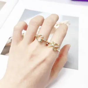 Elegant gold-plated initial rings G and R embellished with sparkling zircon crystals