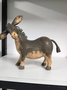 Detailed view of a handcrafted rustic resin donkey figurine with textured antique finish