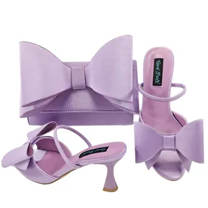 Elegant lavender satin high heel sandals and matching bow clutch bag set for women