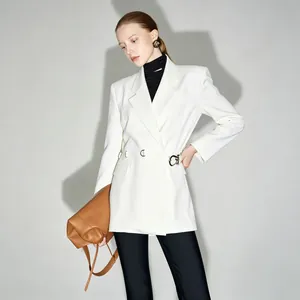 Detail shot of elegant white slim-fit blazer featuring a stylish waist buckle design.