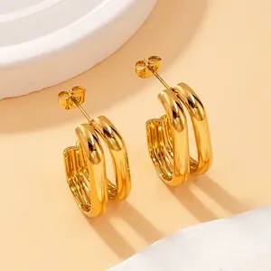 Macro view of geometric double-layer gold-plated titanium steel earrings for women