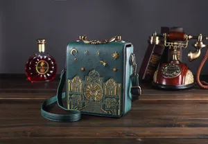 Detailansicht der retro dunkelgrünen Handtasche mit aufwendiger goldener Uhrenstickerei