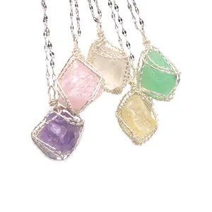 Detailed view of handmade silver wire wrapped raw stone pendant necklaces in multi colors