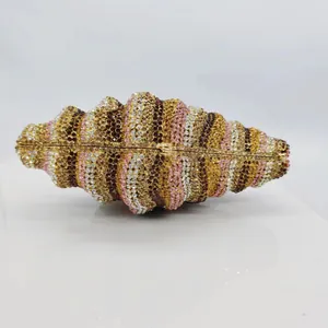 Detailed view of luxury shell-shaped conch evening clutch bag with colorful rhinestones