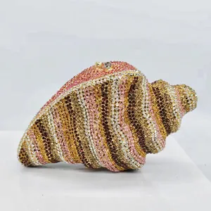 Detailed close-up view of a shell-shaped evening clutch bag with multicolored rhinestones.
