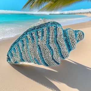Detailed view of the shell-shaped conch evening bag with blue and white rhinestones