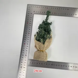 Detailed view of 20cm mini artificial Christmas tree with rustic burlap base for tabletop decor