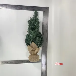 Detailed view of a 40cm mini artificial Christmas tree with a rustic burlap base.