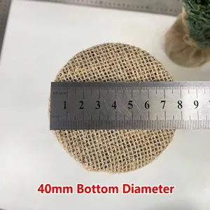 Close-up view measuring the 8.5cm burlap base diameter for a 20cm mini Christmas tree.