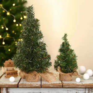 Mini 20cm artificial Christmas trees with burlap bases for festive holiday decor.