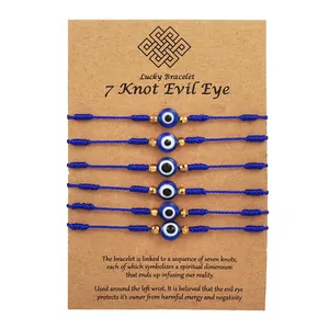 Detail view of 6 blue 7-knot evil eye protection bracelets on brown display card stock