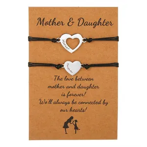 Matching mother and daughter heart charm bracelets set on sentimental kraft gift card display