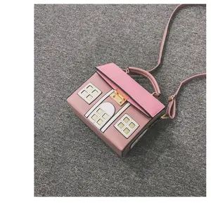 Unique pink house-shaped cartoon crossbody bag featuring top handle and gold clasp