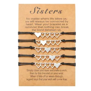 Detailed close-up of five hollow heart bracelets on a decorative kraft paper card.
