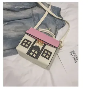 Creative house-shaped crossbody handbag with pink roof and metal clasp details