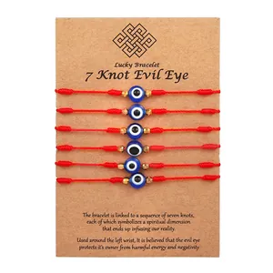 Set of 6 red 7-knot evil eye braided bracelets on kraft display card