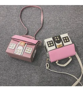 Detailed view of creative house-shaped crossbody bags in pink and white contrasting colors