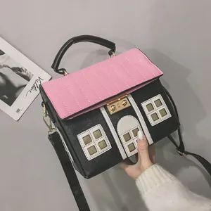 Creative house-shaped crossbody handbag with a pink roof flap and black textured body.