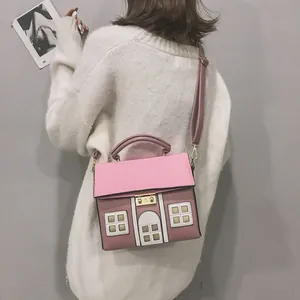 Creative house shaped crossbody bag with cute cartoon house design in pink and brown.