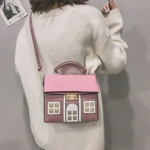 Detailed view of a creative house-shaped crossbody bag in pink and mauve