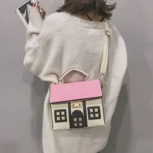 Detailed view of a creative house-shaped handbag in pink and cream with window details
