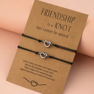 Close-up detail of two black knot bracelets on a kraft friendship wish card gift