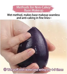 Detailed view of a purple teardrop makeup sponge being squeezed under running water