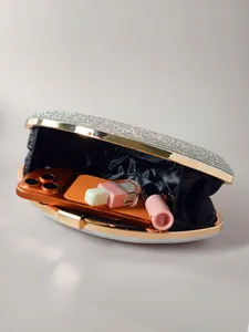 Détails de la pochette en strass montrant la capacité intérieure pour téléphone et maquillage