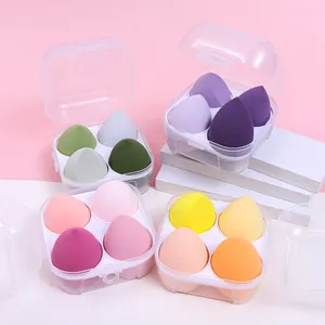 Close-up detail of four colorful makeup sponge sets in clear storage boxes for display