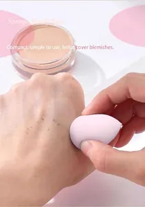 Detailed application of pink teardrop makeup sponge on skin for flawless finish