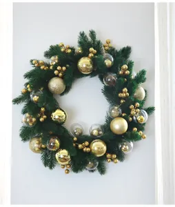 Detailed view of a lush green Christmas wreath decorated with gold balls and berries