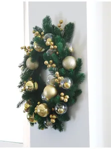 Detail view of a lush green Christmas wreath with sparkling gold and clear ornaments