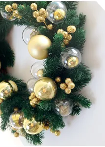 Macro view of green pine needle Christmas wreath decorated with glossy gold balls and bubbles