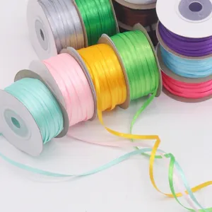 Gros plan de rouleaux de ruban de satin 3-4 mm coloré pour bricolage et emballage cadeau.