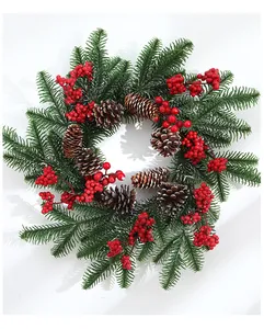 Detailed view of a 50cm Christmas wreath with green pine needles and red berries.