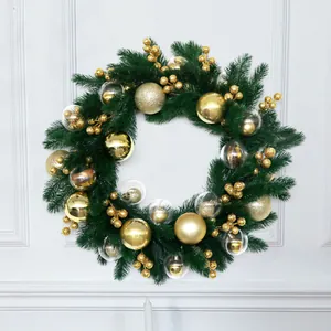 Festive Christmas wreath featuring green pine needles and elegant gold ball ornaments