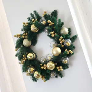 Lush Christmas wreath with pine needles, gold baubles, and clear bubble ornaments