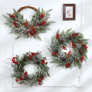 50cm frosted Christmas wreath featuring pine cones and red berries for festive wall decor