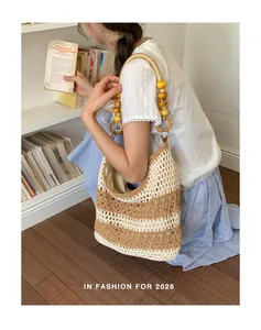 Detailed lifestyle view of a handmade crochet woven bag with wooden bead handle.