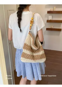 Handmade crochet beach bag with wooden bead strap shown in a warm interior setting