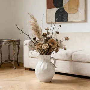 Artisan textured white ceramic pitcher vase featuring a rustic dried flower arrangement
