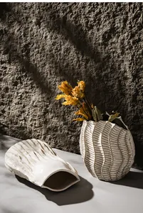 Detailed macro view of white Wabi-sabi ceramic vase with textured wavy surface