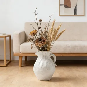 Modern minimalist white textured ceramic pitcher vase with dried flower arrangement