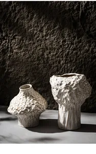 Detail showing the unique textured surface of two off-white Nordic ceramic vases.